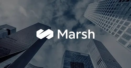 Photo of a view looking up at city skyscrapers with a white version of the Marsh logo superimposed in the middle foreground