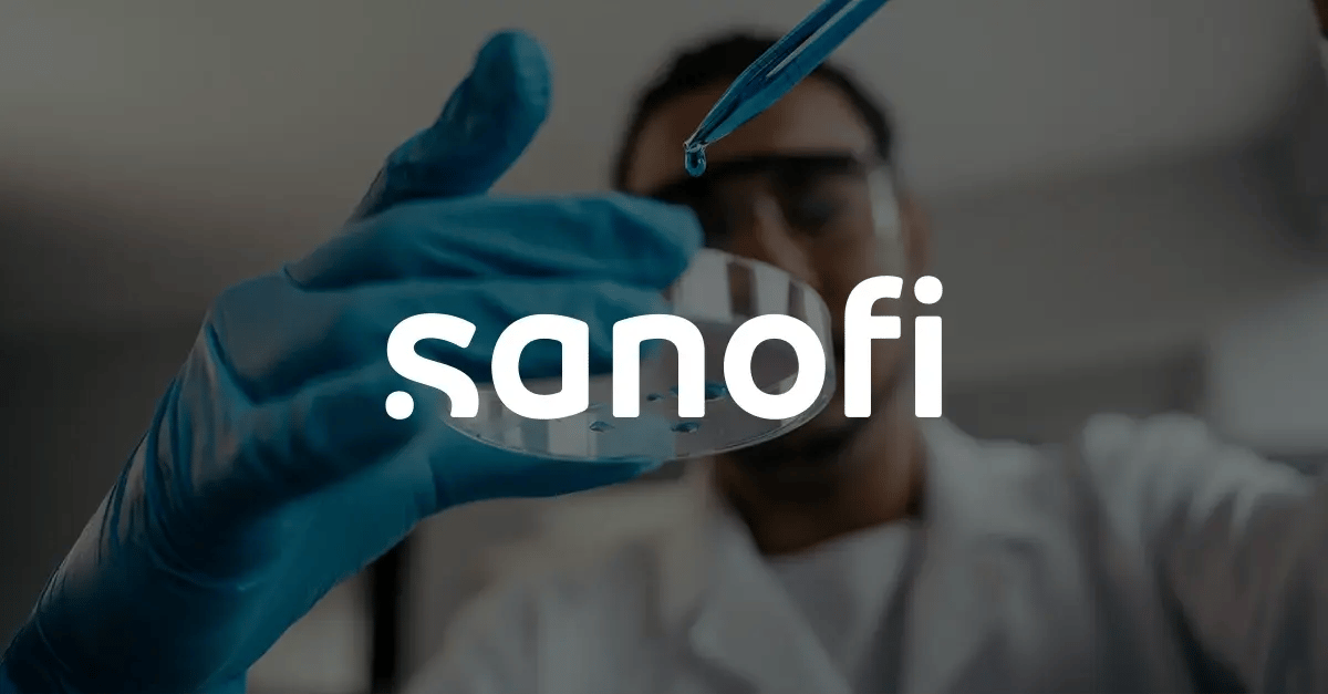 Photo of a man in a lab coat and PPE holding a Petri dish with a white version of the Sanofi logo superimposed in the middle foreground